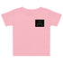 Baby Jersey T-Shirt in Rosa mit schwarzem, geometrischem Druck auf der Vorderseite.